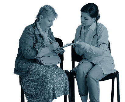 Two women sitting facing each other filling out a form on a clipboard